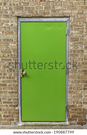 Green door on brick wall