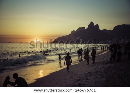 RIO DE JANEIRO, BRAZIL - JANUARY 2015: People relaxing on Ipanema Beach during beautiful hot summer sunset.