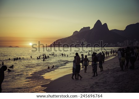 RIO DE JANEIRO, BRAZIL - JANUARY 2015: People relaxing on Ipanema Beach during beautiful hot summer sunset.