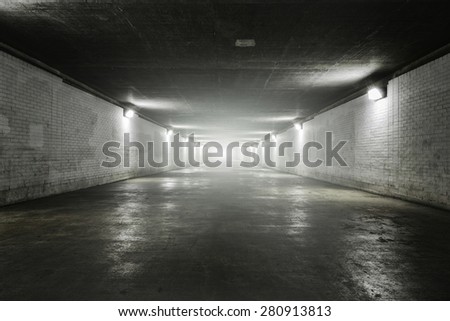 Light at the end of dark tunnel at night