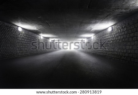 Light at the end of dark tunnel at night
