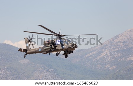 ATHENS, GREECE - SEPTEMBER 28: A Greek Army AH-64A+ Apache attack helicopter over the runway on September 28, 2013 in Tatoi, Athens, Greece. HAF uses 20 helicopters of this type and 12 AH-64D.