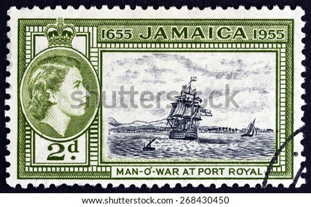JAMAICA - CIRCA 1955: A stamp printed in Jamaica issued for the 300th Anniversary of Jamaica\'s Status as British Territory shows H.M.S. Britannia at Port Royal and Queen Elizabeth II, circa 1955.