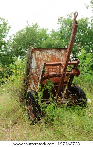 Old rusty tractor trailer standing in the landscape exposed to the elements of nature