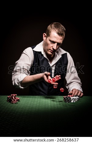 A male gambler rolls the dice after the betting
