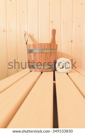 Wooden bucket and towel standing in the sauna