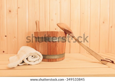 Towel, wooden bucket and wooden spoon to pour water