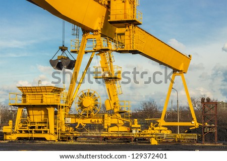 Yellow gantry crane on coal site in heating plant - Poland