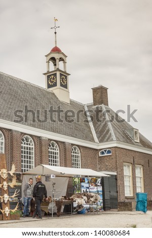 SCHOKLAND, NETHERLANDS - APRIL 21: People on Scandinavian day street party on april 21, 2013 in Schokland. Schokland is beauty old UNESCO village.
