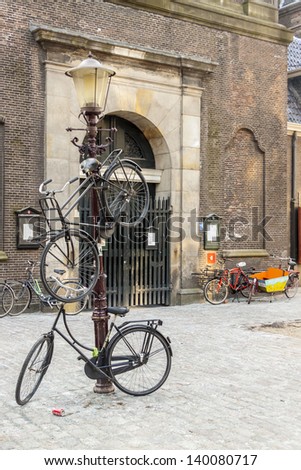 AMSTERDAM, NETHERLANDS - APRIL 22: Bicycles in Old town of Netherlands Capital on april 22, 2013 in Amsterdam. It is estimated that there are about 550 thousand bikes in Amsterdam.