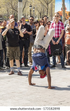 Paris, France - April 25:B-Boy Doing Some Breakdance Moves In Front A Street Crowd, At Arch Of Triumph On April 25, 2013 In Paris. Its Popular Form Of Earnings In Big Cities.