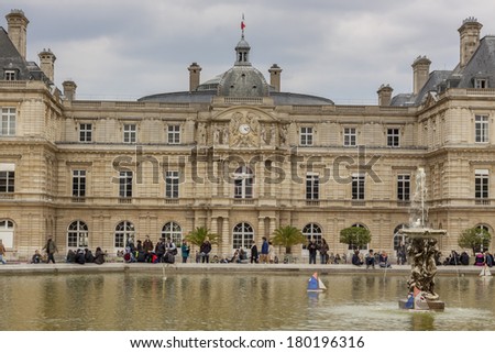 PARIS, FRANCE -  APRIL 27:Tourist in  Luxembourg Garden  on april 27, 2013 in Paris.Park with 224,500 square meters, this is the second largest public park in Paris.
