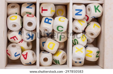 Wooden letters in the box - creative game.