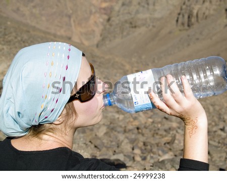 Tired women in Atlas mountains in morocco drinking water