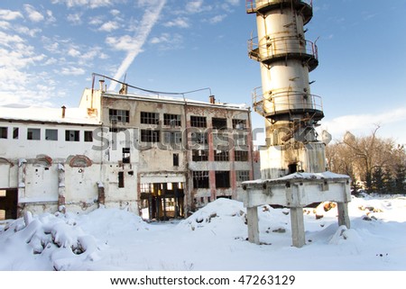 Old abandoned factory. Winter day a lot of white snow blue sky - Poland.