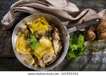 Second Dish With Ravioli With Mushroom Sauce Presented In a Frying Pan