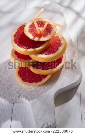 Aperitif with slices of red grapefruit on white-border