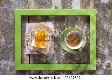 presentation of a breakfast of coffee, bread, butter and jam