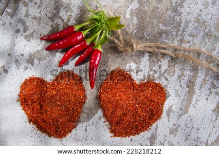 Presentation of two hearts made of chili powder