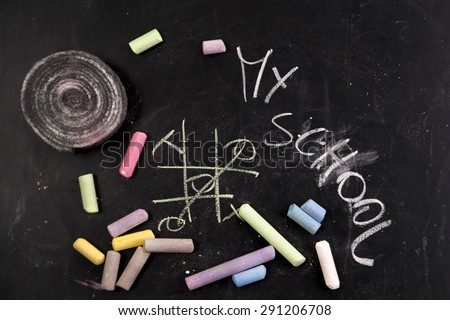 Drawing with chalk on the blackboard to represent the beginning of new school year
