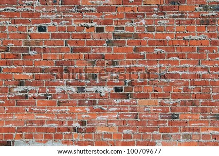 Landscape style photo showing an aged brick wall with mortar between bricks unfinished giving an oozing appearance./Oozing Mortar Brick Wall / Great texture, background,or example of early brick work.