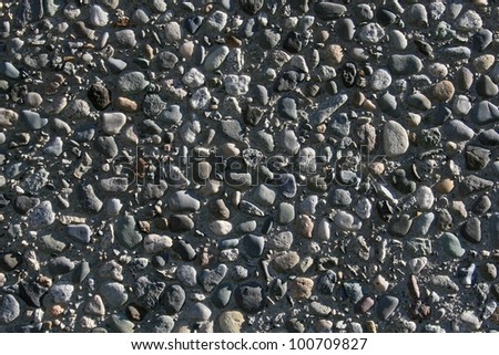 Landscape style photo of aggregate rock embeded in concrete./ Aggregate Rock Embeded in Concrete / Great texture, background or example of concrete work.