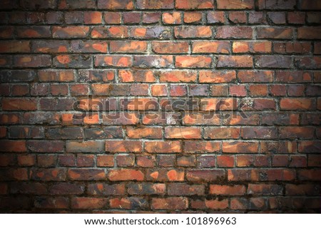 Old,aged,variegated, 1890\'s brick wall, moss growing in mortared seams, with spot light on the middle. / Great Background, texture or backdrop.