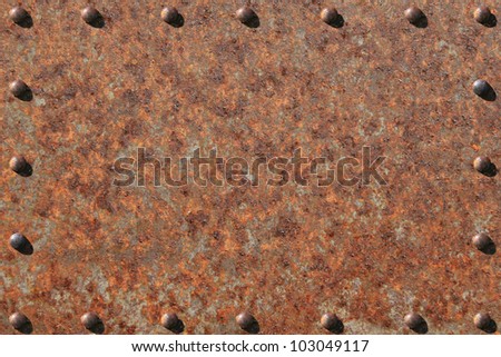 Heavily rusted metal plate, with rusted, riveted edges. / Rusted Steel, Riveted Edges / Great background for text, painting, or whatever your notion.