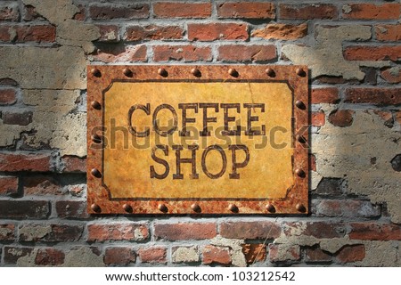 Coffee shop sign on rusted metal plate, rusted, riveted edges.That, on a very old brick wall./ Rusted Coffee Sign on 1890\'s Brick / Grunge for sure, good look for espresso bar, cafe, or coffee shop.