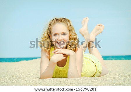 beautiful blonde woman on sand beach. Slim happy girl resting smiling and enjoying summer sun. Romantic lady having fun at vacation holidays. Alluring model at exotic spa resort