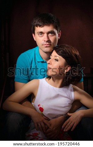 Happy couple in love posing in studio. Loving couple embracing. Beautiful woman and man in casual summer clothes. Relationship/ Boyfriend and girlfriend on dating.