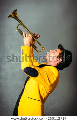 Handsome musician trumpet player playing trumpet at studio. Jazz-band