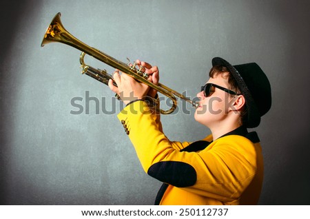 Blind musician trumpet player playing trumpet at studio. Jazz-band