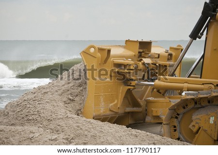LONG BEACH ISLAND,NJ-NOVEMBER 3:A bulldozer pushes sand back up to the dunes after it was lost from the tidal surge caused by Hurricane SandyNov 3 2012, Long Beach Island, NJ