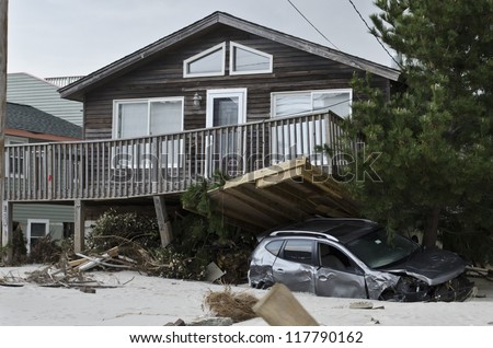 LONG BEACH ISLAND,NJ-NOVEMBER 1: A car is pinned under the deck of house after being swept away by the powerful storm surge caused by Hurricane Sandy in Holgate.Nov 1 2012, Long Beach Island, NJ