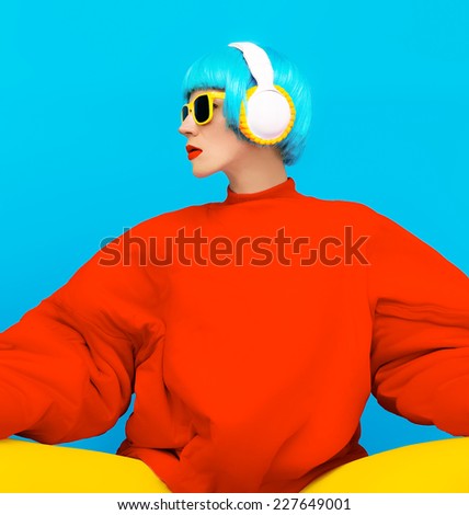 Glamorous Fashion Lady in bright clothes listening to Music. All Shades of Music