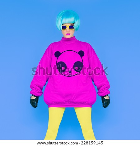 Fashion Lady loves Panda. Funny photo. Girl in in bright wig on a blue background. Japanese style