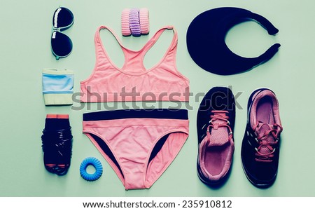 Lady fitness style. Sports Accessory Set on green background