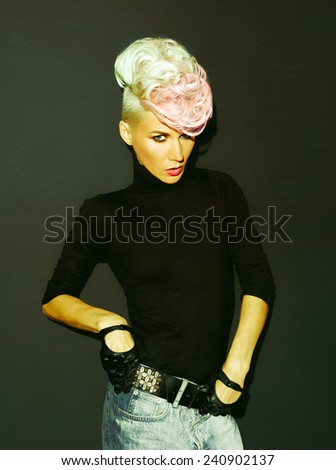 Blond model on black background.  Stylish haircut. Punk style