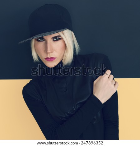 Stylish Blonde in black cap and black shirt. Latest fashion trends