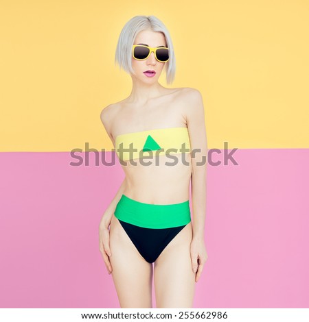 Blond model in fashionable bright swimsuit. Trend of the summer season.