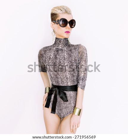 Lady in fashionable Swimsuit and Accessories. Snake print trend of the season