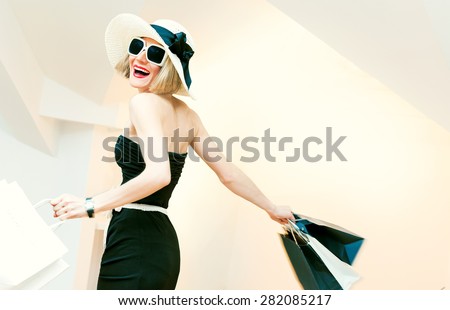 Happy Shopping Woman with shopping bags in motion