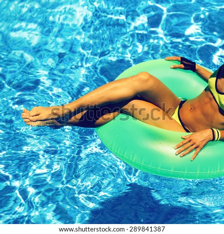Glamour Girl with inflatable circle in pool. Party Summer Style