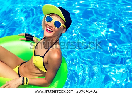Happy Glamour girl with inflatable circle in Pool.  Party Summer Style