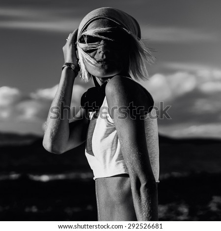 Stylish Model in fashionable Clothes in Desert black and white photo