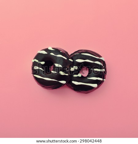 Chocolate Donuts on pink Vanilla background