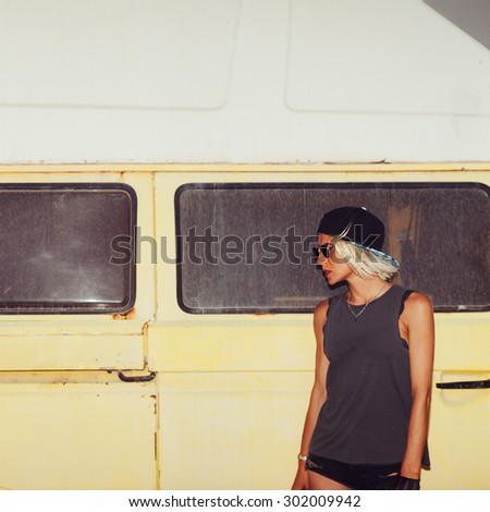 Stylish Girl stands near Minibus. Surf Fashion style