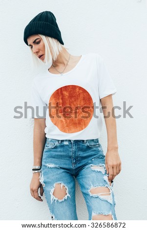 Stylish look.  Ragged vintage Jeans and fashionable T-shirt