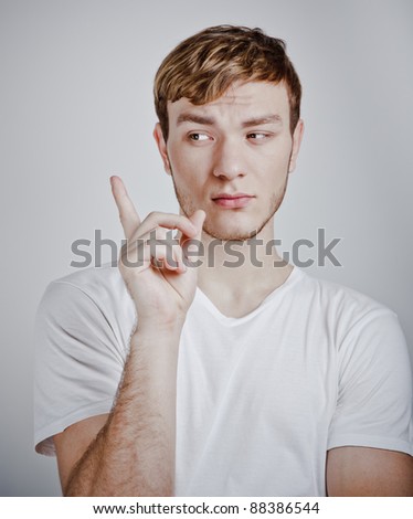 portrait of young man pointing with finger